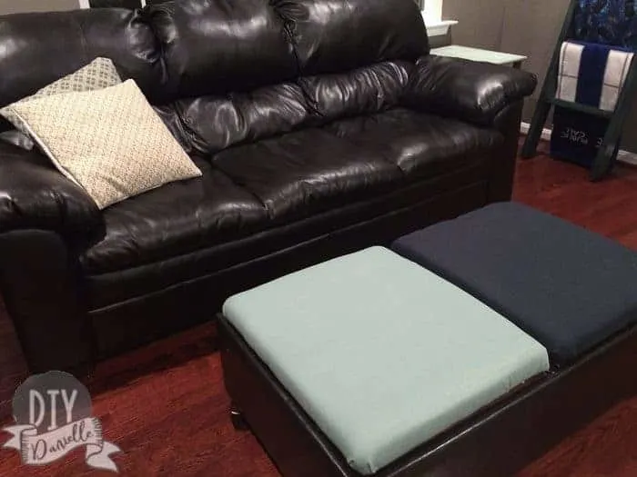 Reupholstered leather ottoman with the leather replaced with regular fabric.
