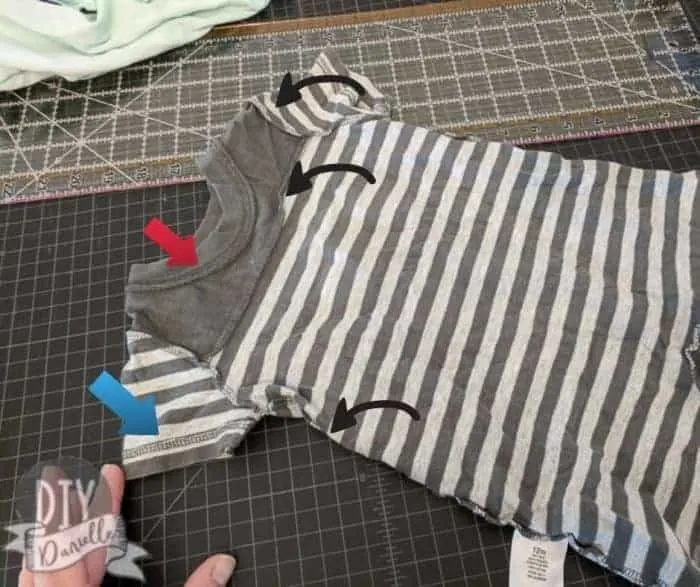 Baby romper, insides out, with arrows pointing to how the clothing piece was constructed.