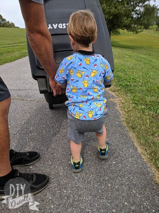 Back of a boy's shirt as he pushes a garbage can: This is a handmade Raglan style shirt.