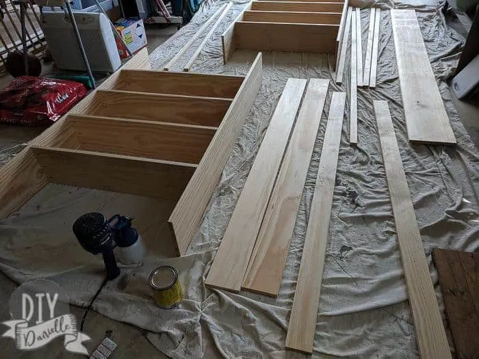 Laying out the wood to stain on top of a drop cloth.