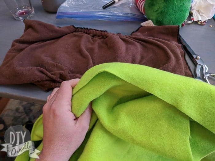 Green fleece for a larger brown cloth diaper.