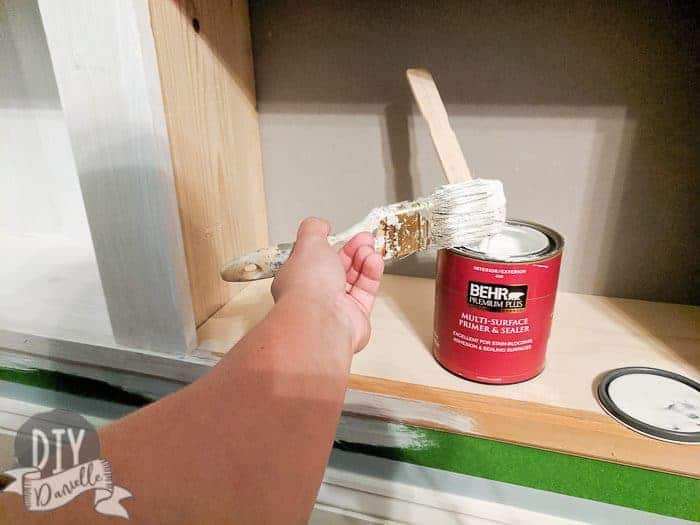 Priming the back of the drywall and the raw wood.