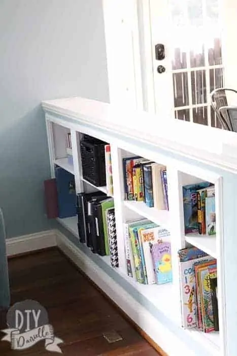 DIY Recessed Shelving tucked into a half wall between our kitchen and living room. This is a great way to create new space.