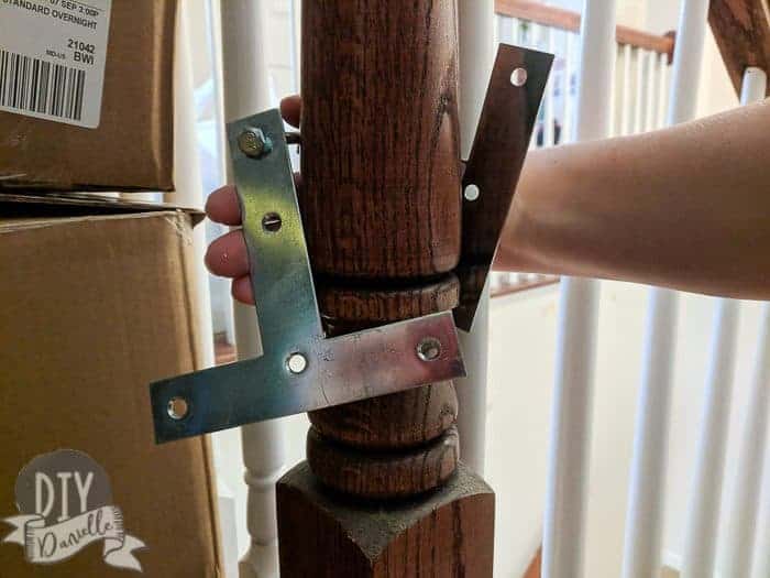 Removing the gate from the banister. No damage to the wood.