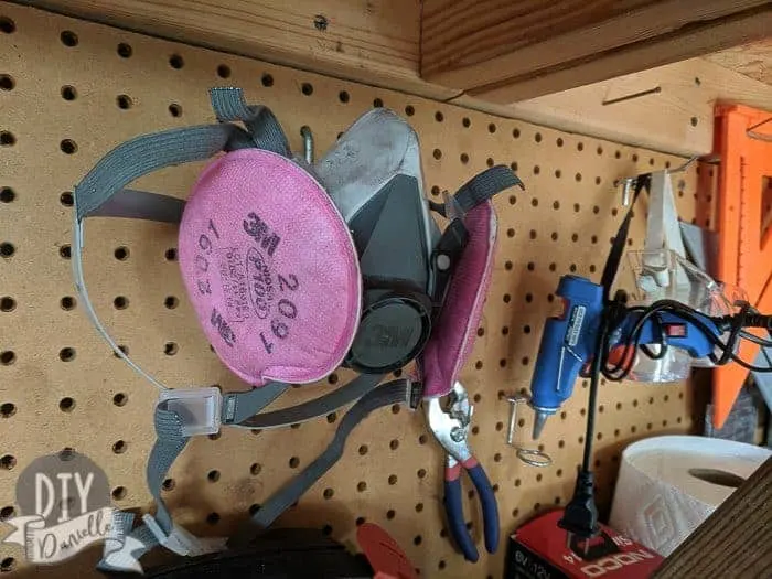 Pink 3M respirator hanging on my workbench where I can find it!