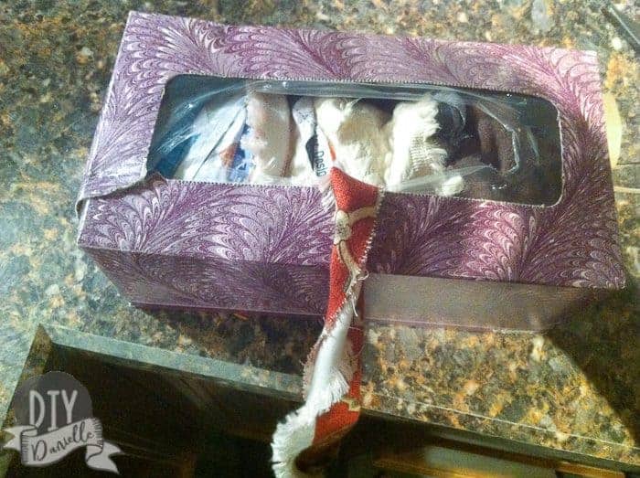 Old kleenex box stuffed with fabric scraps tied together.