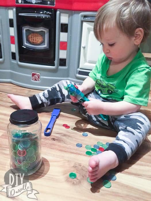 Toddler playing with magnetic Bingo wands.