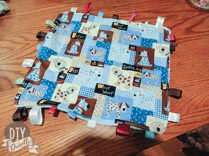 Quilting down the wipes container inside the tag blanket.