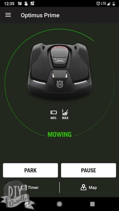 App indicating the mower's charge with options to park or pause it.