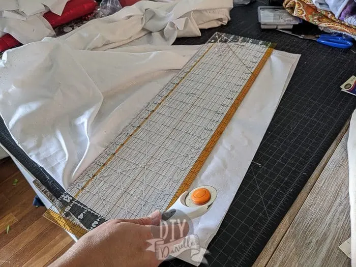 Using a rotary cutter to cut the strips of fabric.