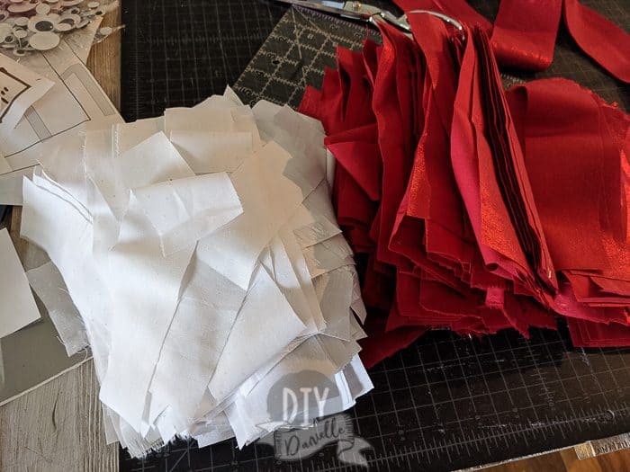 Piles of red and white fabric strips.