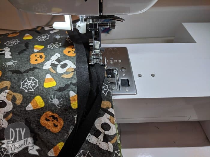 Sewing bias tape on the bags.
