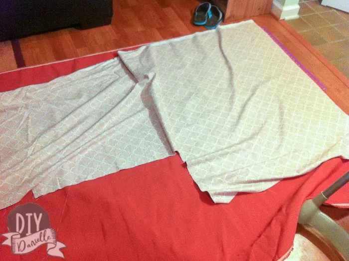 Sewing fabric together to make an L shaped cover for the couch.