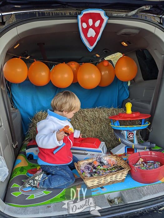 My 2 year old snacking on candy and treats while playing with Paw Patrol toys until the trunk or treat events finished. 