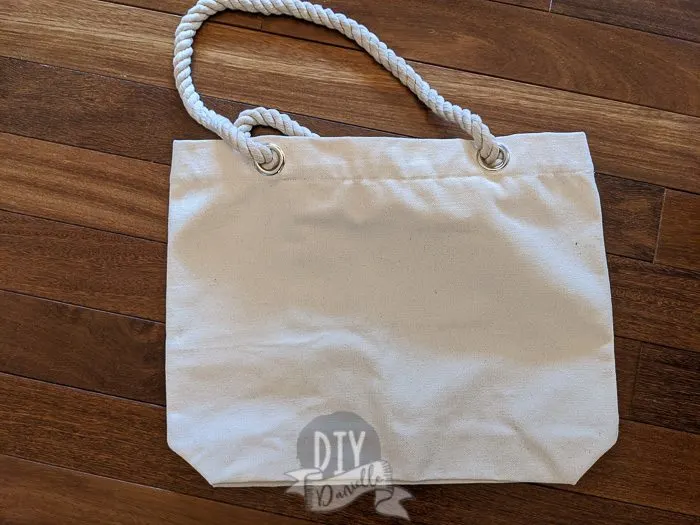 Blank tote bag, canvas, with rope handles and silver grommets. 