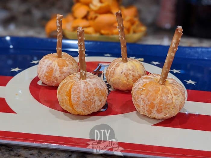 Oranges with a pretzel stick in the top to act as a "stem"