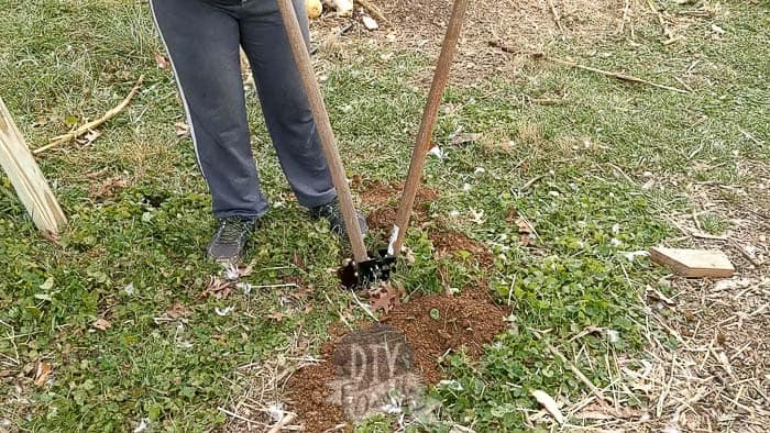 Open handles on the post digger before removing soil from post hole.