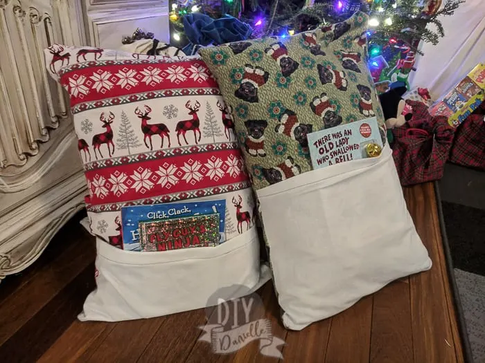 Christmas book pillows with a book inside them, by the Christmas tree.