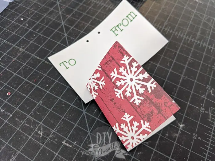 Folding gift tags with to and from written on them by Cricut