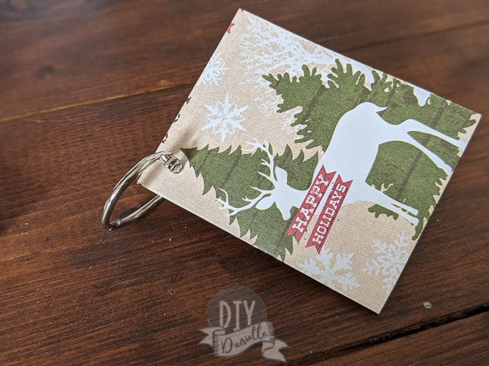 Folding gift tags with a binder ring through them.