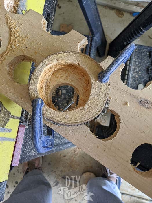 Cutting center holes in the wood cuts.