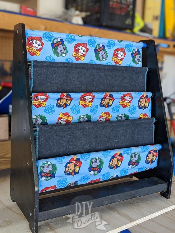 Repaired sling wood book rack with new Paw Patrol fabric to match my son's room.
