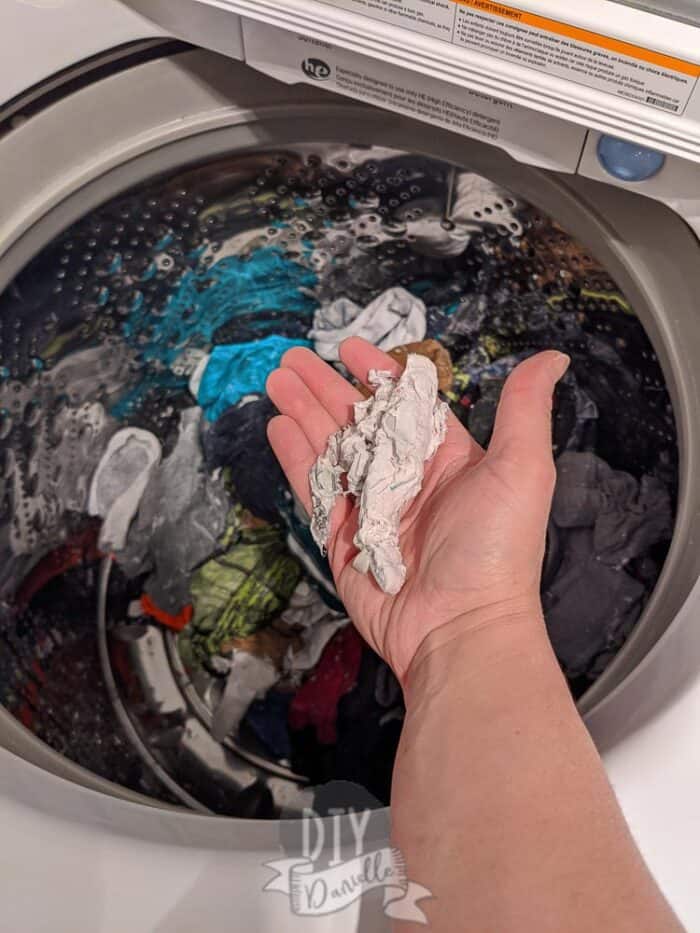 Removing large chunks of paper from washing machine.