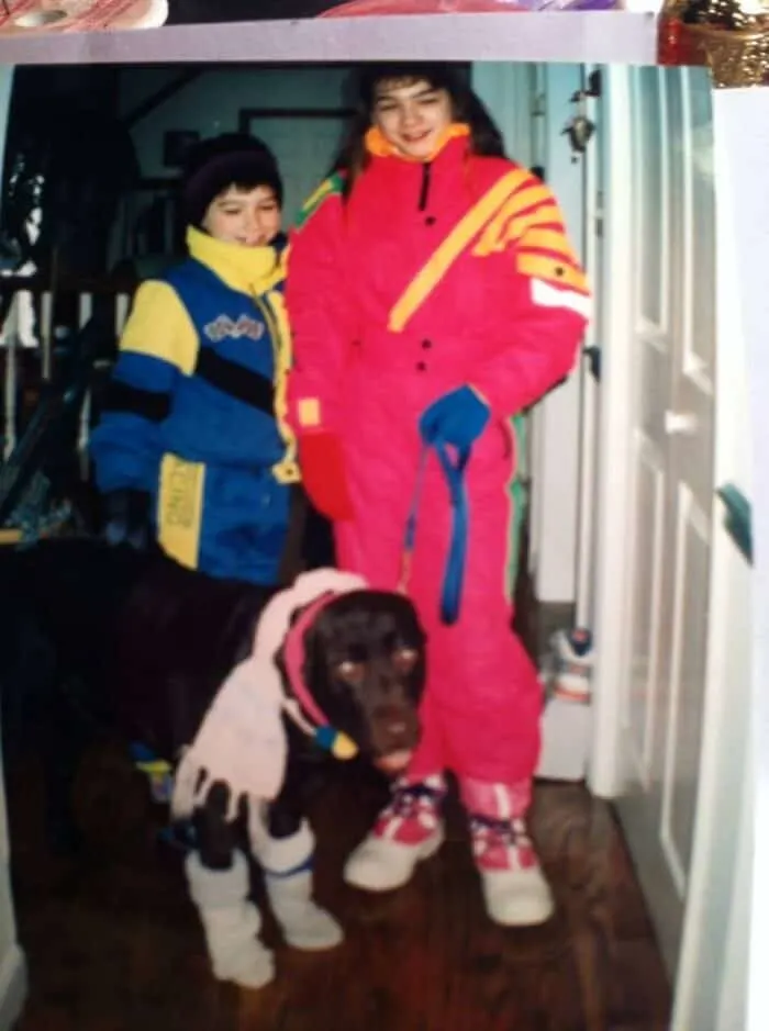 Picture of Danielle in the 1980s in full 80's snow gear and big hair. Dog and brother dressed up too!