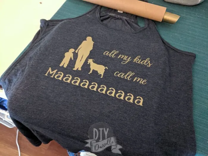 "All my kids call me maaaa" with a woman, baby, and goat on a shirt. 