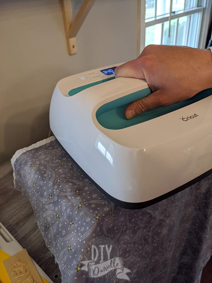 Using the EasyPress to apply iron on vinyl to a wood box. Piece of cotton between the box and heat press.