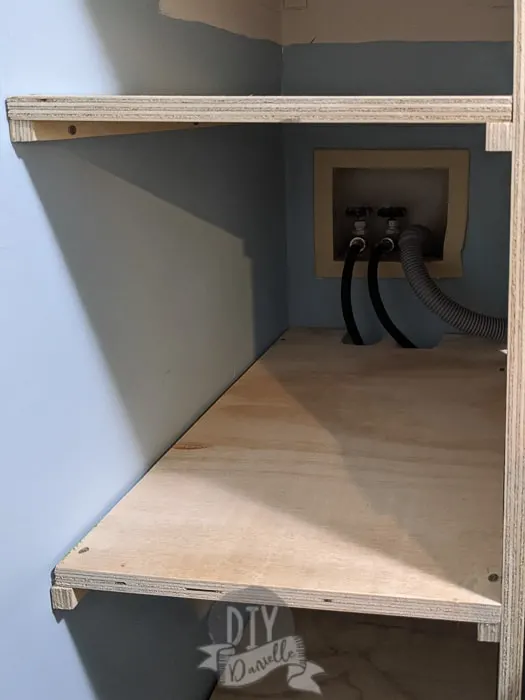 Placing shelves and a support along the wall for the other side of the shelf. 
