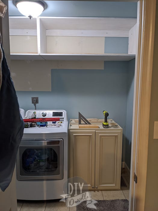 Mudroom shelves hung up at the top of the room. 