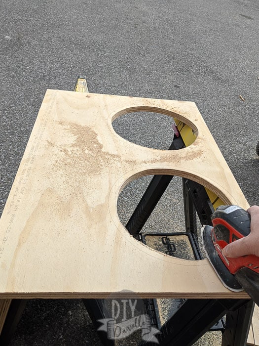 Sanding the edges of where I cut out the holes for the dog bowls. 