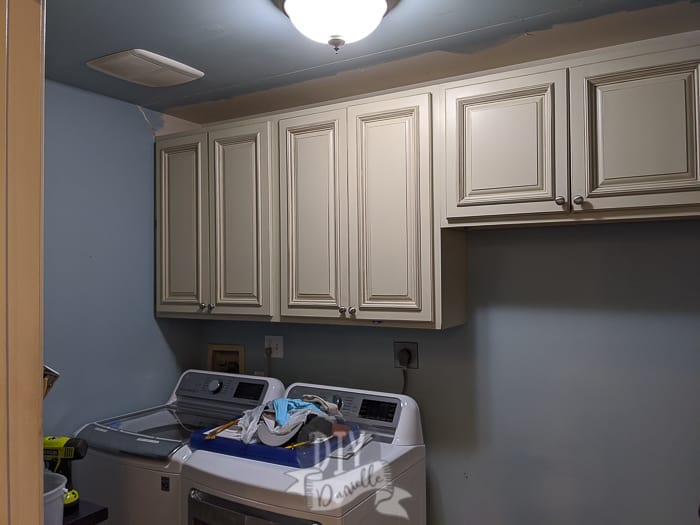 Removing the cabinets in the laundry room. First we removed the trim over them.