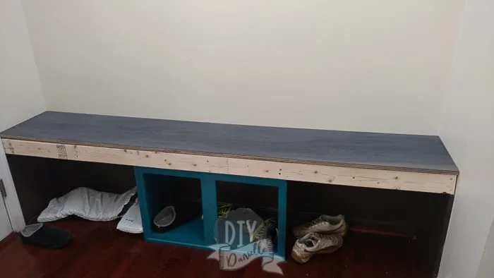 Plywood on top of the frame for the bench.