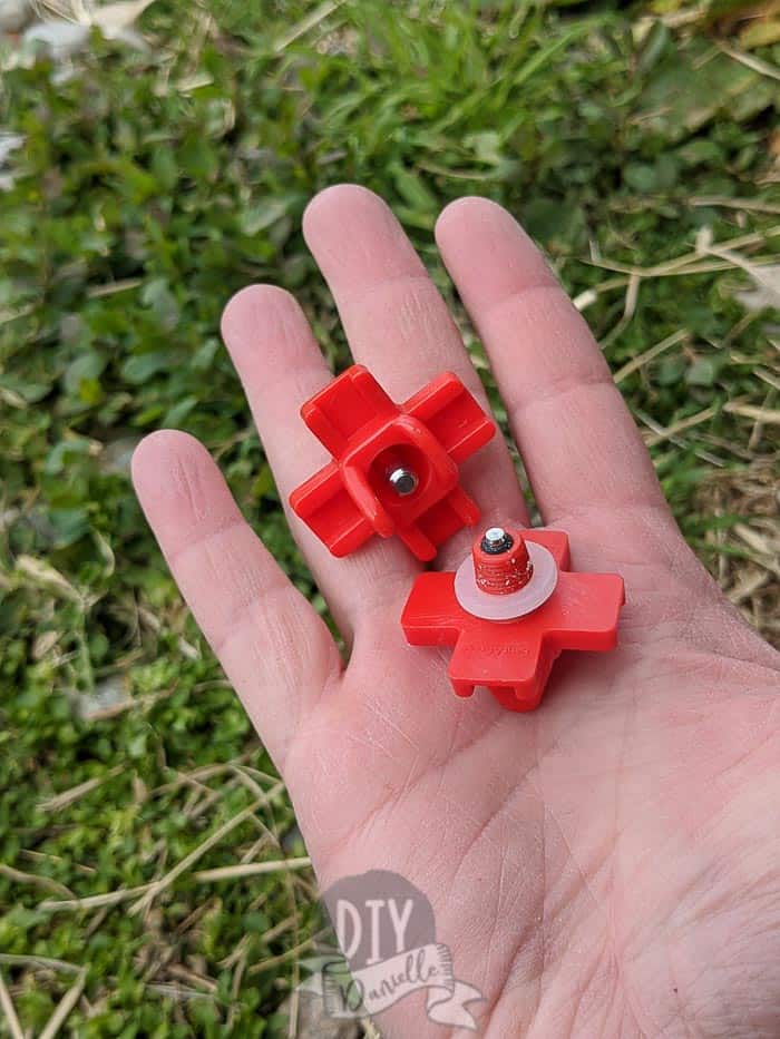 Close up of the back and front of the chicken nipples that you insert into your bucket.