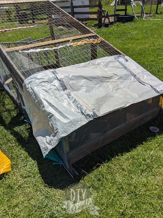 Old feed bags being duct taped together to act as a cover from the rain.