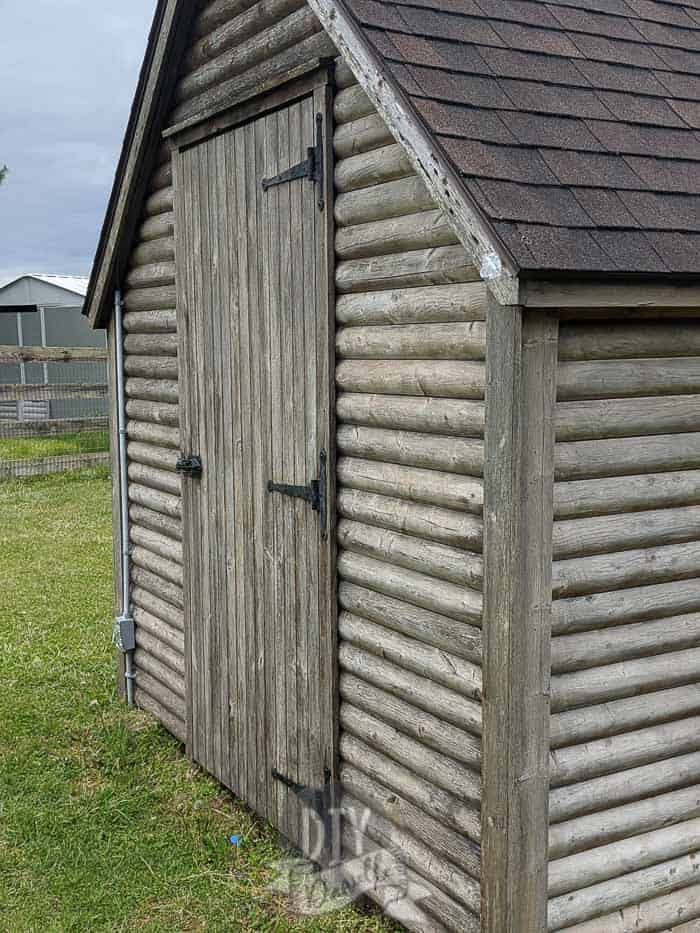 "Washed" wood of the log cabin playhouse. The top isn't done yet because I didn't have a ladder.