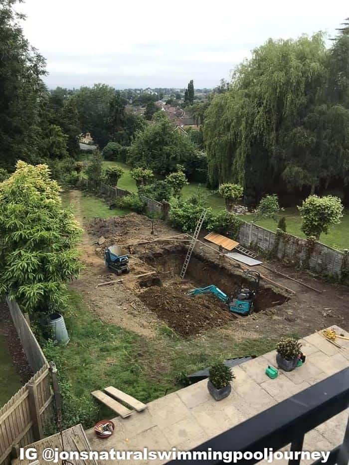 Using a small digger to dig out the pool to a 7' depth.