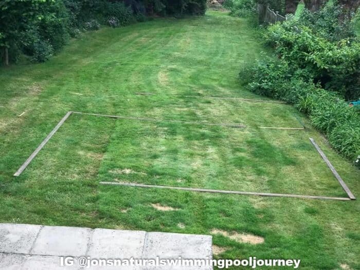 The lawn before the swimming pond was adding. Wood laid out for the shape of the pool.