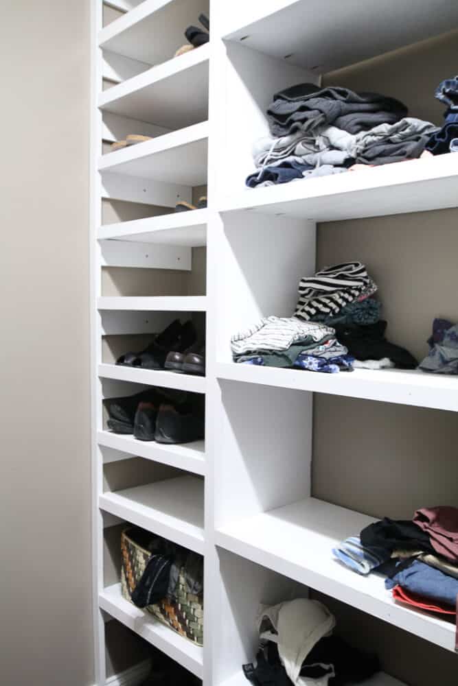 Shoe shelf using side supports along an interior wall. I needed to use a lot of wall anchors here and it was very time consuming. (White shelves with shoes on them)