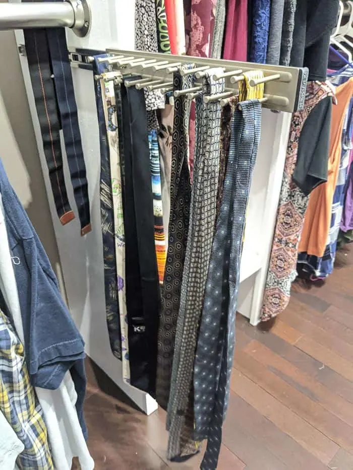 Silver/Chrome Tie rack that slides out from closet. It needs to be screwed into wood shelving or the wall. 