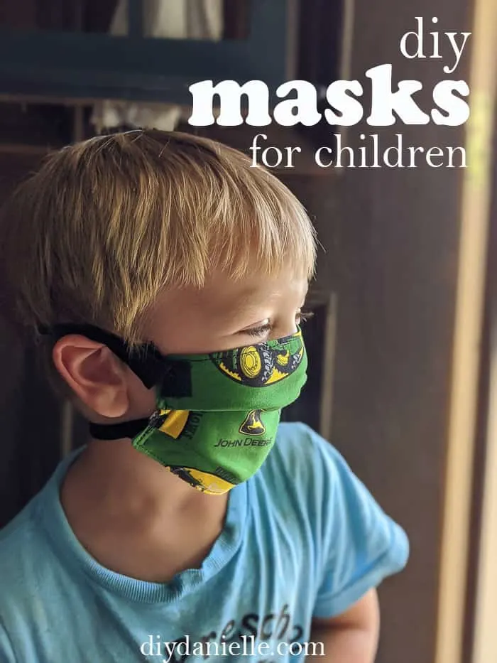 DIY Masks for Children: 3 year old boy with blond hair wearing a John Deere mask with breakaway straps.