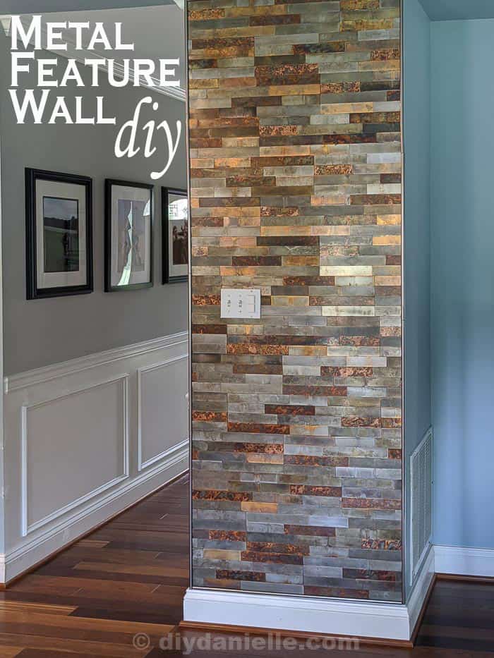 Metal Feature Wall DIY. Light blue kitchen walls next to a feature wall made with distressed metal stick on tiles.