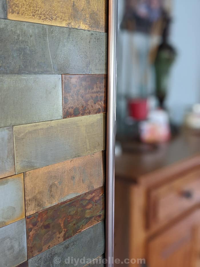 Trim for our metal feature wall. Closeup shot of the slight gap between the top of the tiles and the trim.