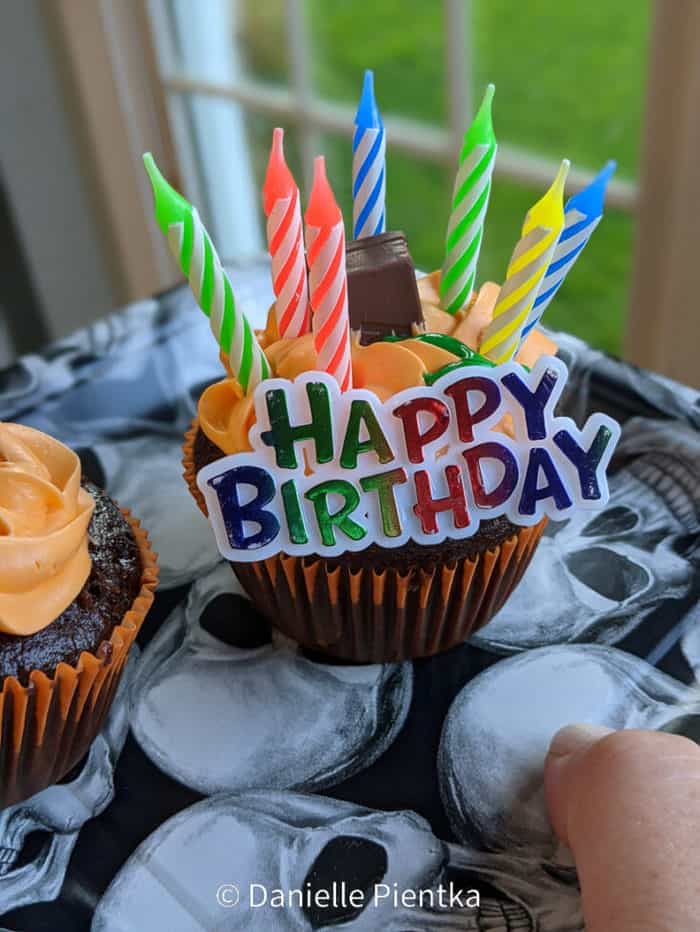 Eggless cupcake with pudding filling, chocolate and orange frosting.