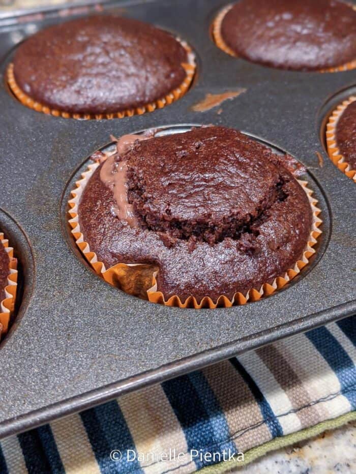 Replacing the top on the pudding filled cupcake.