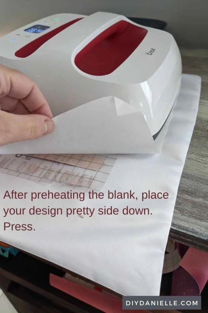 After preheating the blank, place your design pretty side down with butcher paper on top. Press.