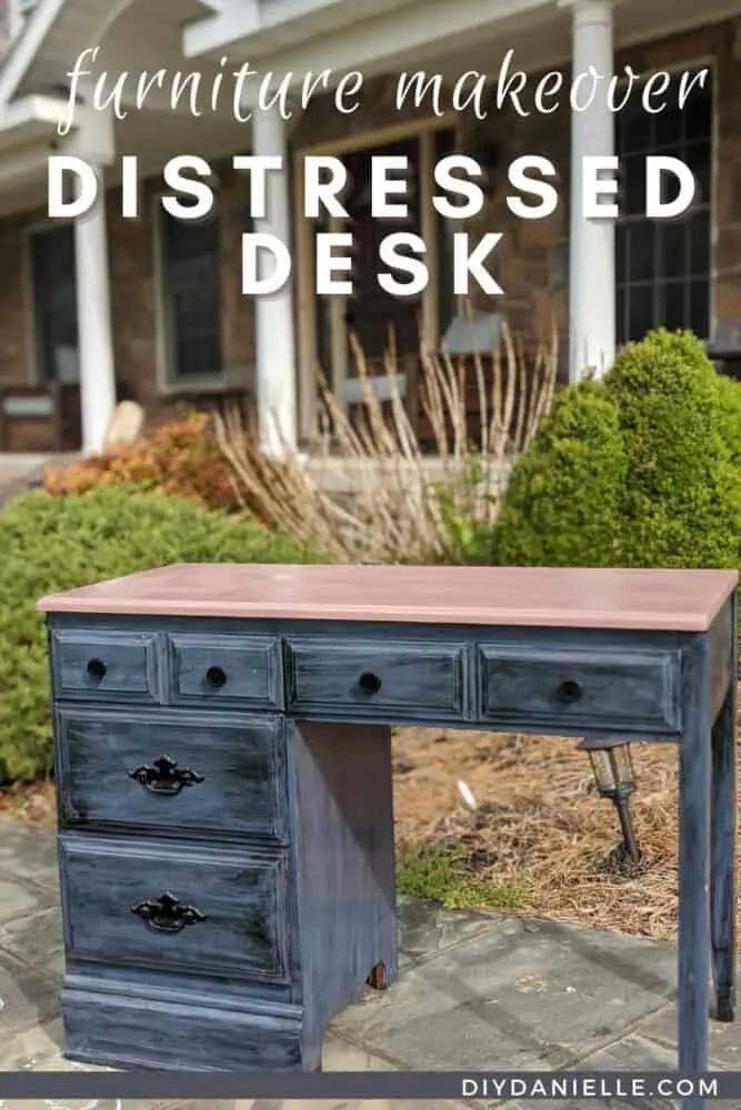 DIY Distressed Desk with dark blue and black bottom and a pink desktop. 