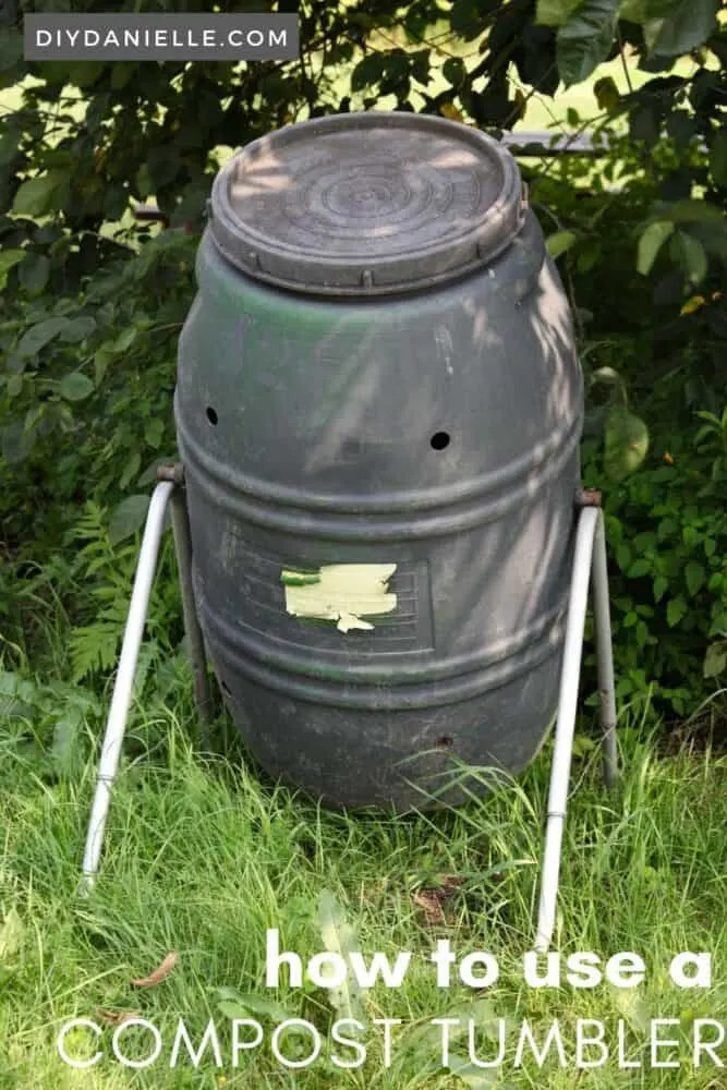 This large compost tumbler can be turned manually. It is black to attract heat, and has holes for drainage and water to moisture the compost inside.